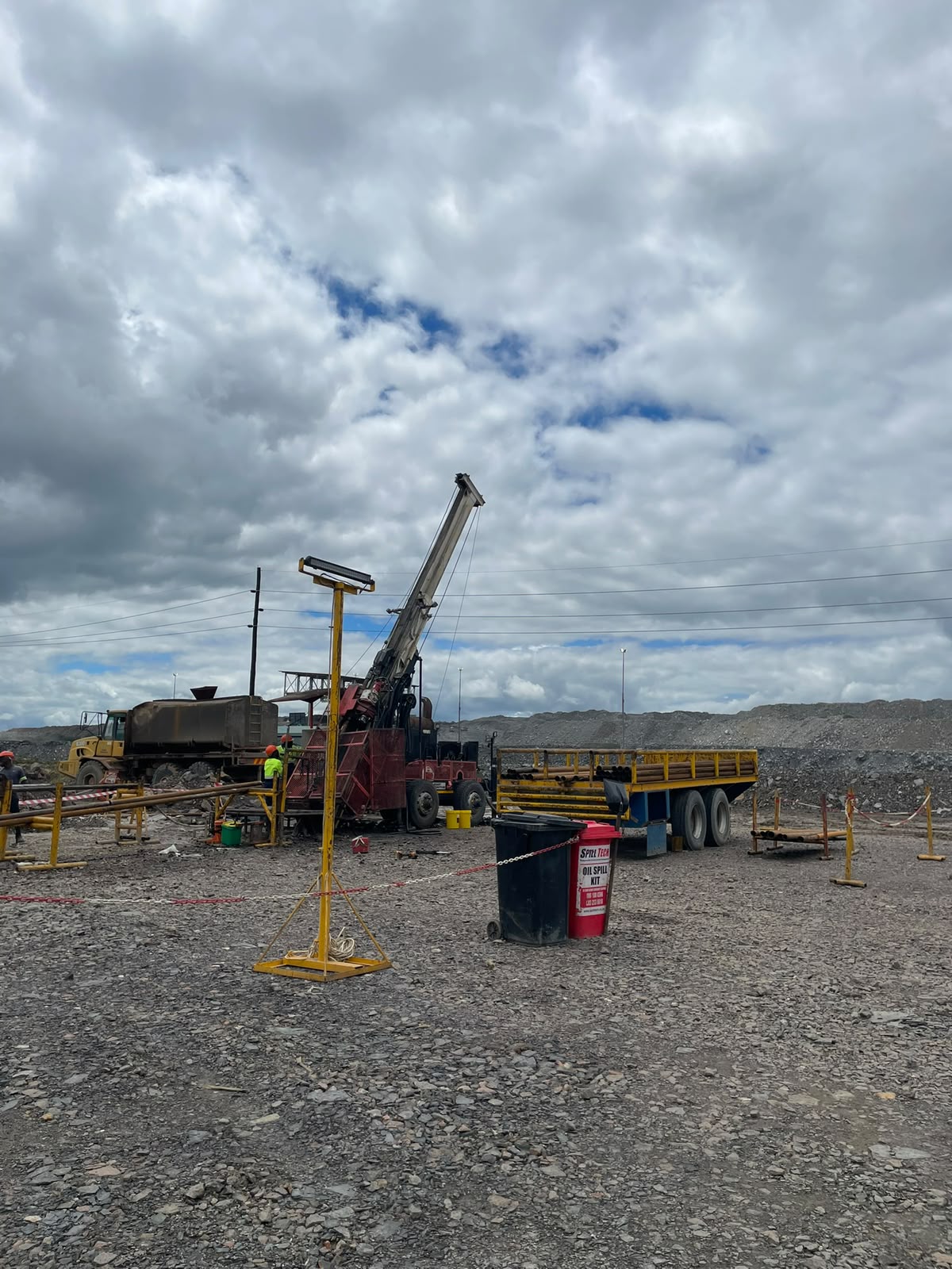 Barricaded drill site on an open-pit mine with oil spill kit and safety lighting